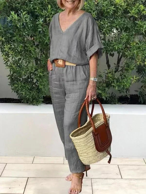 Gray V-neck two-piece set with draped sleeves and matching ankle-length pants