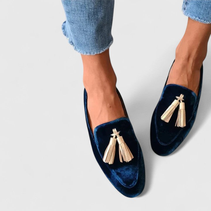 Blue velvet slip-on flats worn with jeans, tassel fringe at front