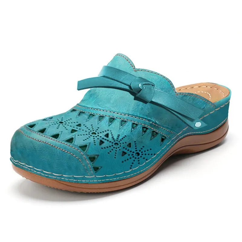 Teal cutout slip-on clogs for women with side strap and decorative perforations