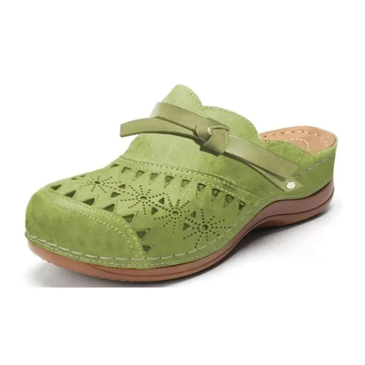 Light green cutout slip-on clogs for women with side strap and lace-like cutouts