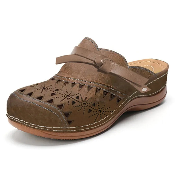 Brown cutout slip-on clogs for women with side strap and geometric cutout upper