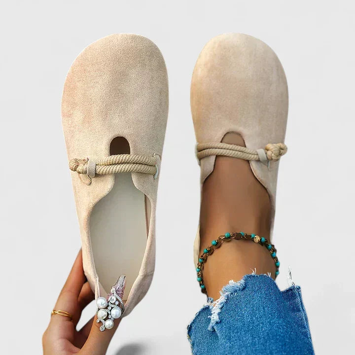 Beige slip-on flats with rope detail across the instep and rounded open toe