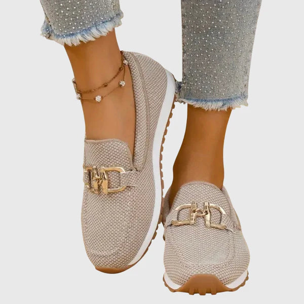 Beige women's comfort slip-on loafers with gold-tone buckle detail and textured upper