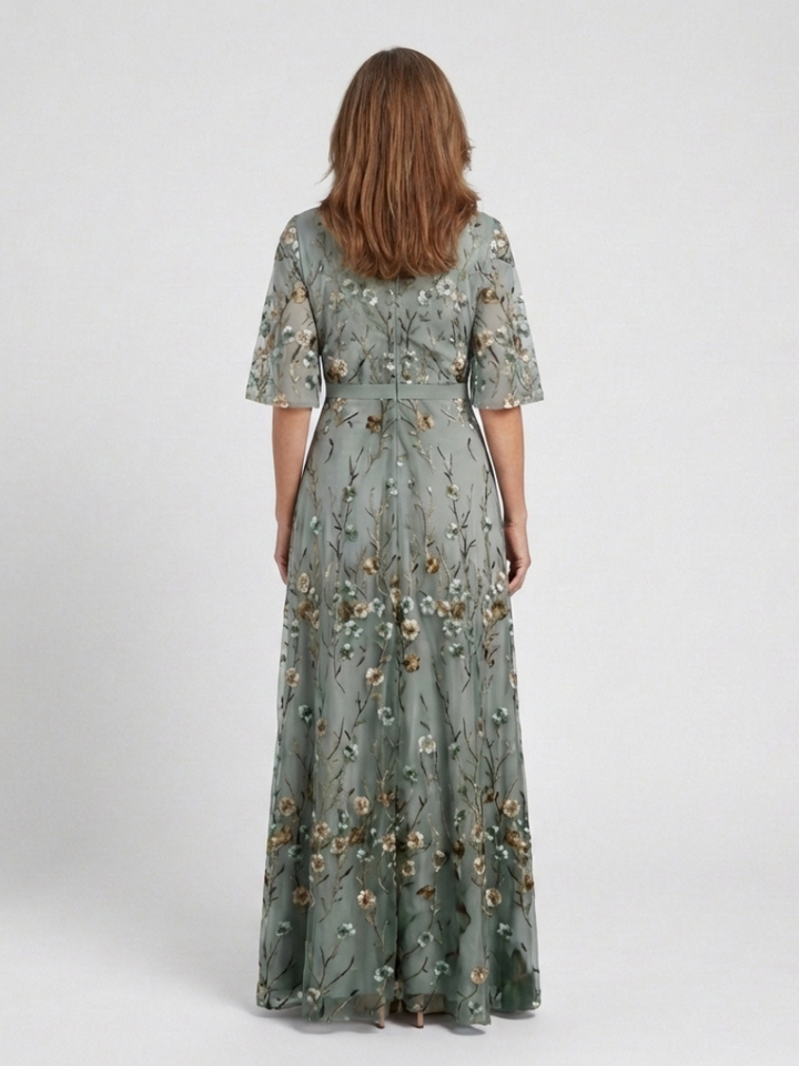 Green floral V-neck short-sleeve maxi dress, back view with gathered flowing skirt