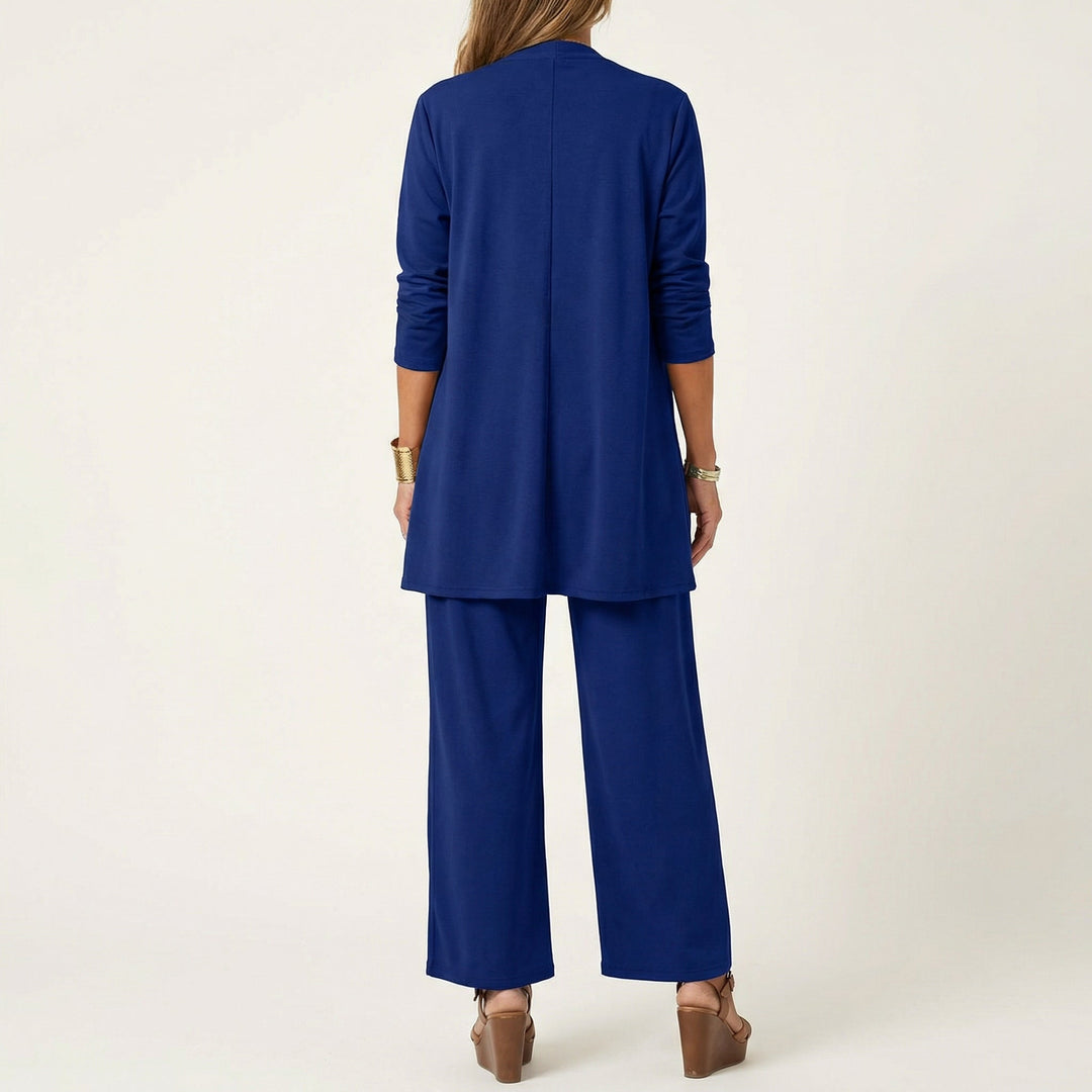 Blue minimalist 3-piece set, back view: long tunic jacket and wide-leg pants.