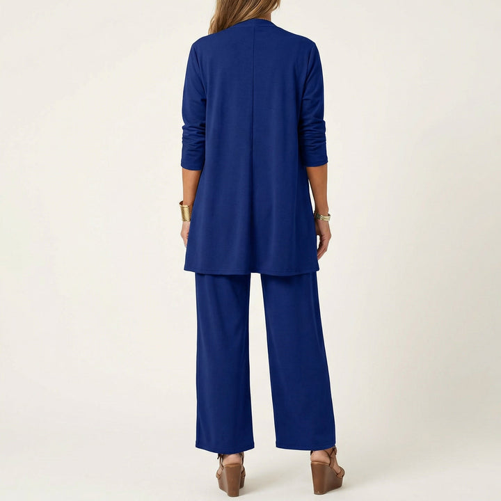 Blue minimalist 3-piece set, back view: long tunic jacket and wide-leg pants.