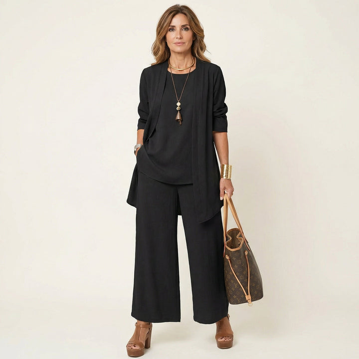 Black minimalist 3-piece set with tunic jacket, draped top, and wide-leg pants.