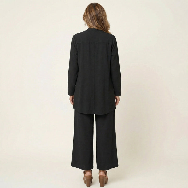 Black minimalist 3-piece set, back view: long tunic jacket and wide-leg pants.