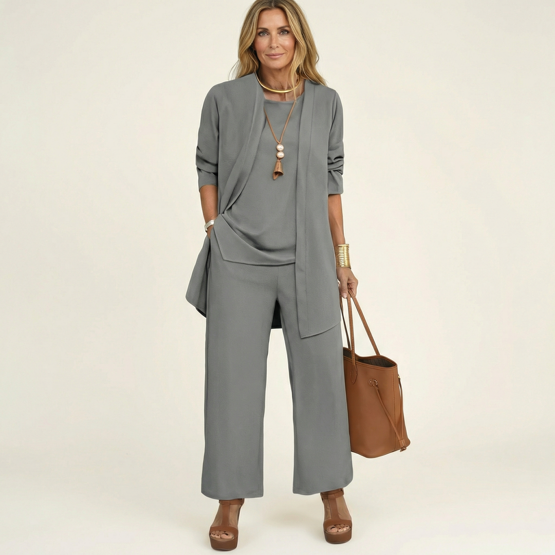 Gray minimalist 3-piece set with tunic jacket, draped top, and wide-leg pants.