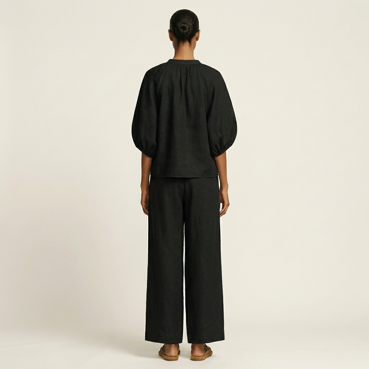 Black zipper-front puff sleeve top and wide-leg pants set, back view
