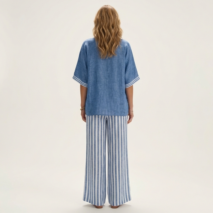 Back view: blue V-neck varsity top with striped wide-leg pants in blue and white