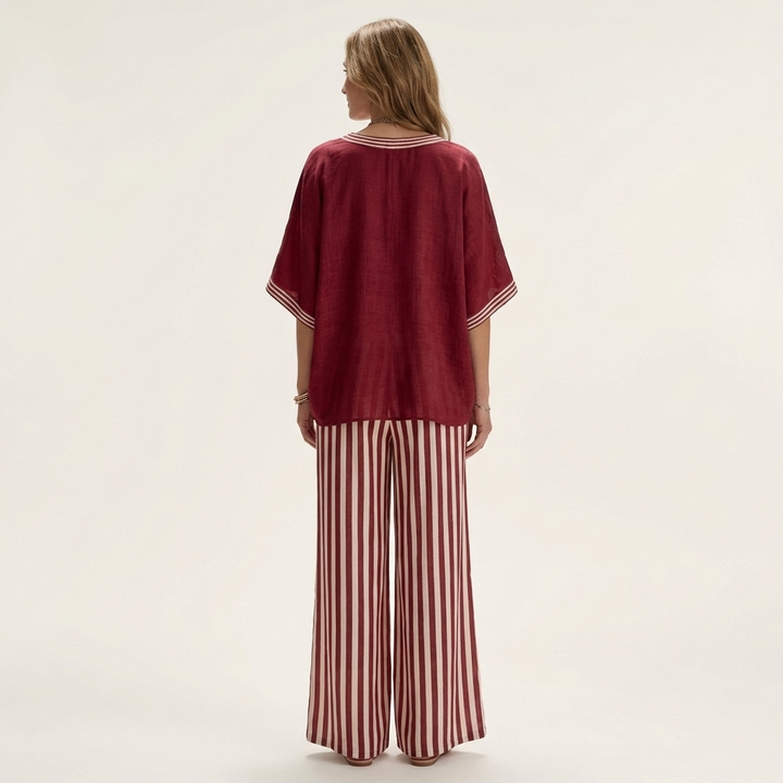 Back view: burgundy V-neck varsity top with striped wide-leg pants in burgundy and white