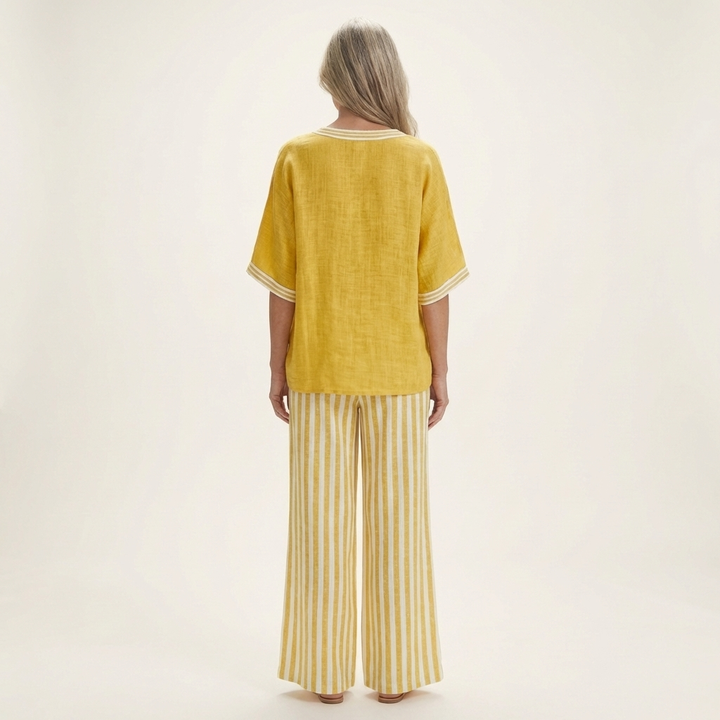 Back view: yellow V-neck varsity top with striped wide-leg pants in yellow and white