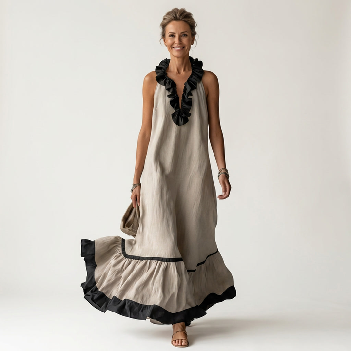 Sleeveless maxi dress front view, white with black ruffle neckline and tiered maxi skirt
