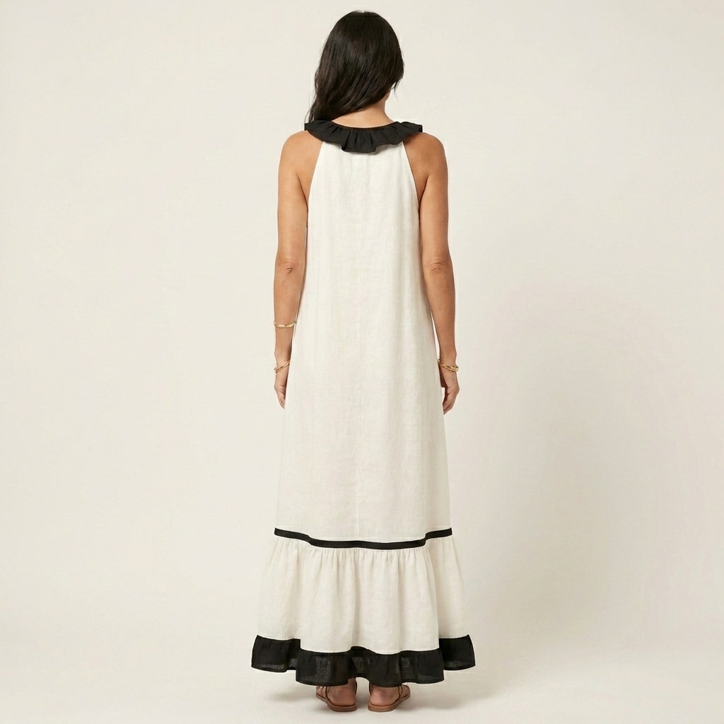 Sleeveless maxi dress back view, white with black contrast trim and tiered hem