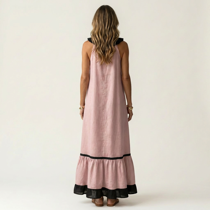 Pink sleeveless maxi dress, back view with ruffle neckline and black contrast trim