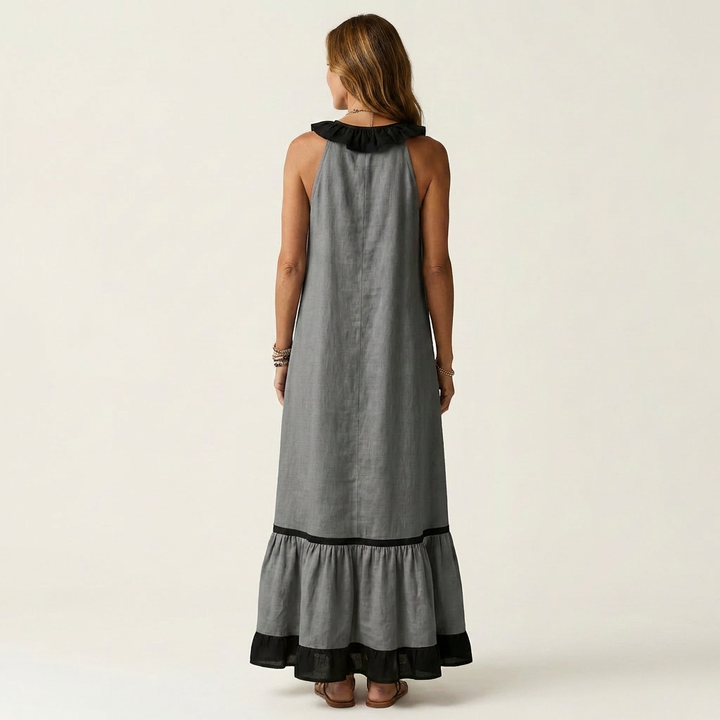 Dark gray sleeveless maxi dress, back view with ruffle neck and black contrast trim