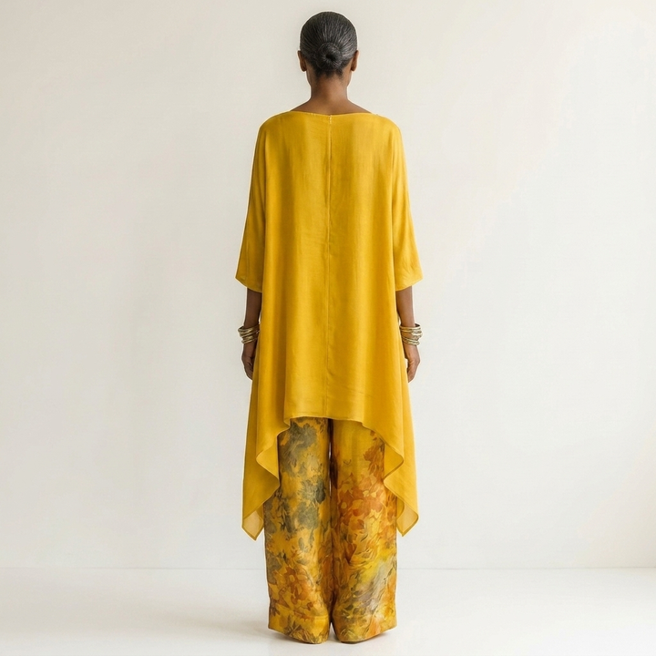 Yellow cotton-silk two-piece set, back view tunic with draped hem and floral printed pants