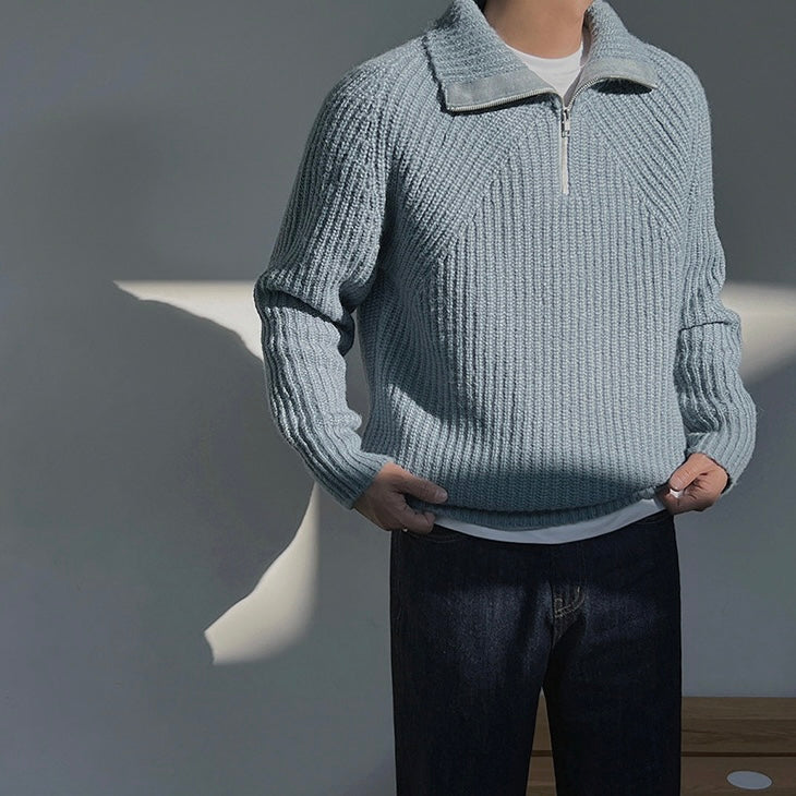 Light blue quarter-zip knit pullover sweater with half-zip closure and ribbed hem.