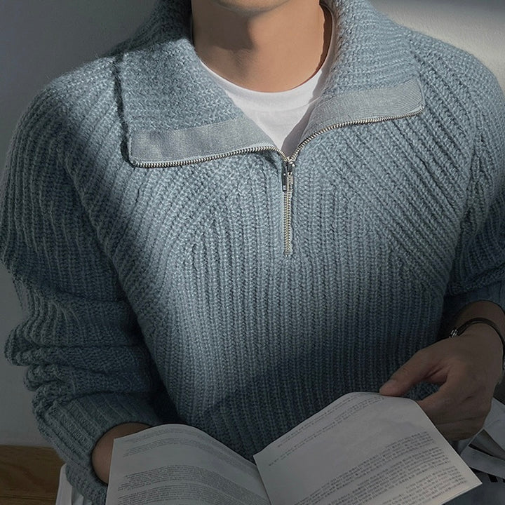 Light blue quarter-zip knit pullover with front zipper placket and textured rib knit.