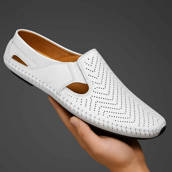 White slip-on sandals with perforated pattern, cut-out sides, and tan interior lining
