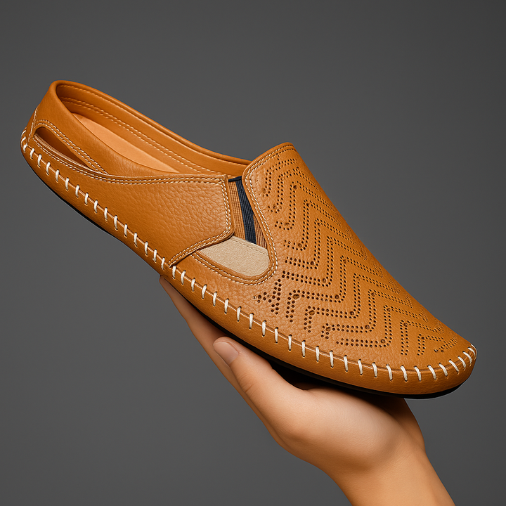 Tan perforated slip-on sandals with moc toe and contrast stitched rubber sole