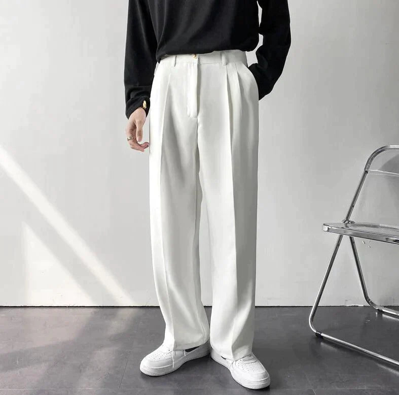 White pleated wide-leg trousers, front view with gathered waist and belt loops