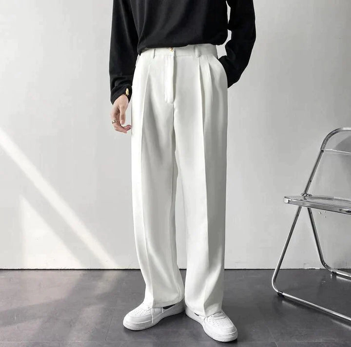 White pleated wide-leg trousers, front view with gathered waist and belt loops