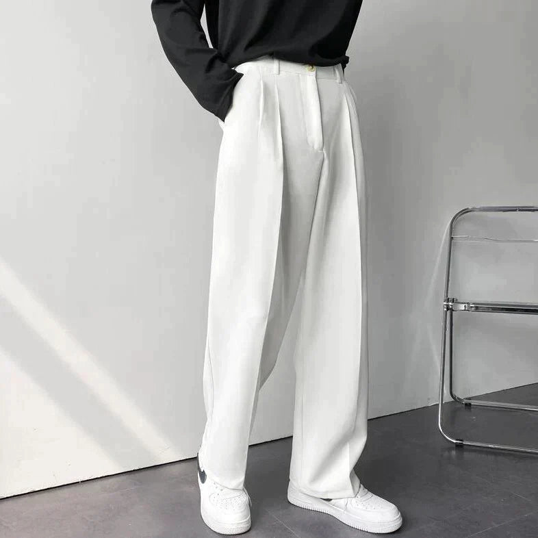White pleated wide-leg trousers, side view with high-rise waistband and loose fit