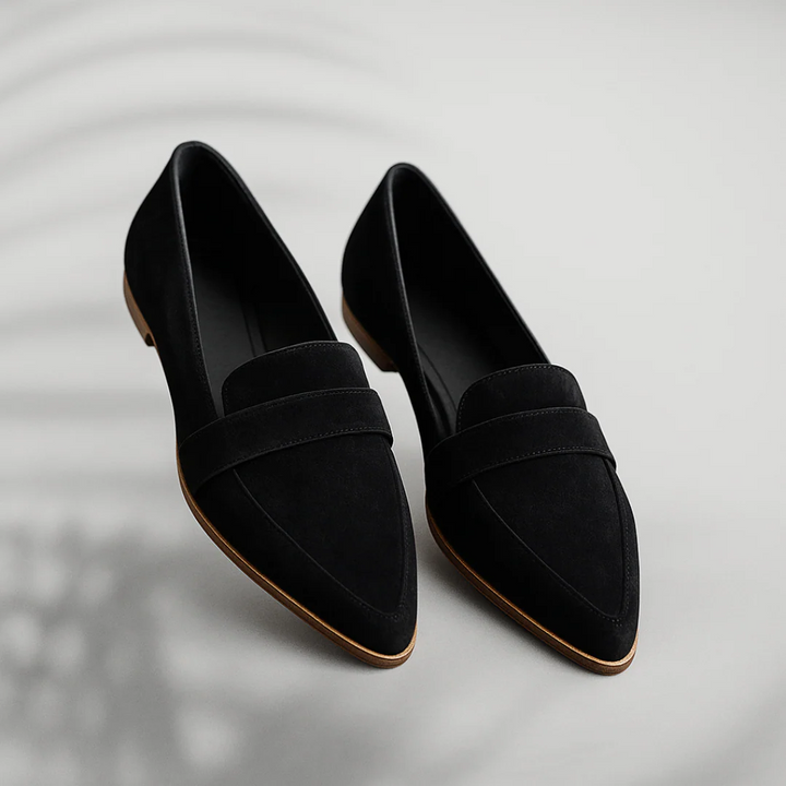 Black slip-on flat with suede-look upper and wide strap, almond toe.