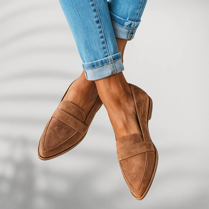 Tan slip-on flat with suede-look upper, stitched strap detail, almond toe.