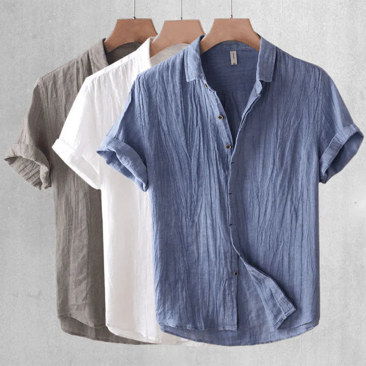 Blue short-sleeve button-up shirt with point collar and curved hem seam detail