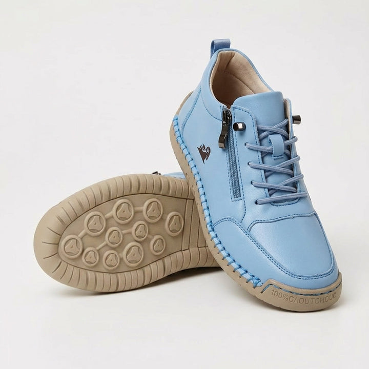 Light blue side-zip lace-up sneakers with side zipper and tan textured outsole
