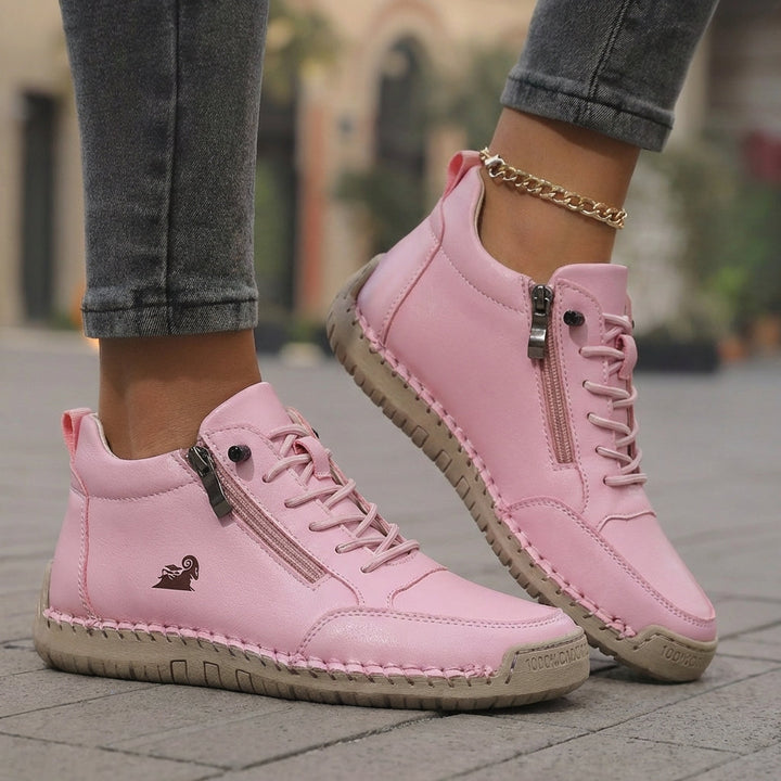 Pink side-zip lace-up sneakers with chain detail, padded collar, and beige sole