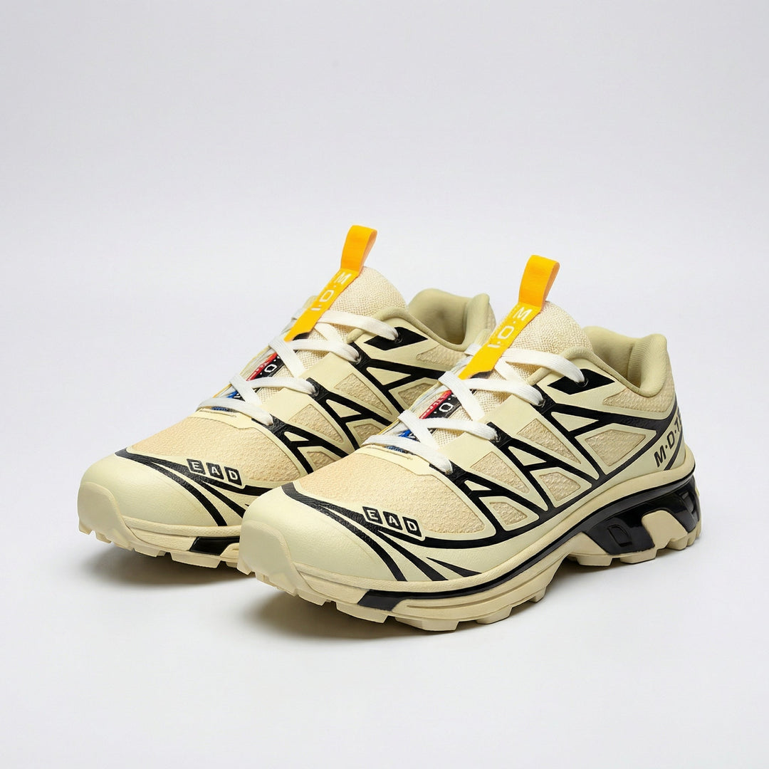 Women’s lace-up walking sneaker in beige with black geometric panels and yellow pull tab
