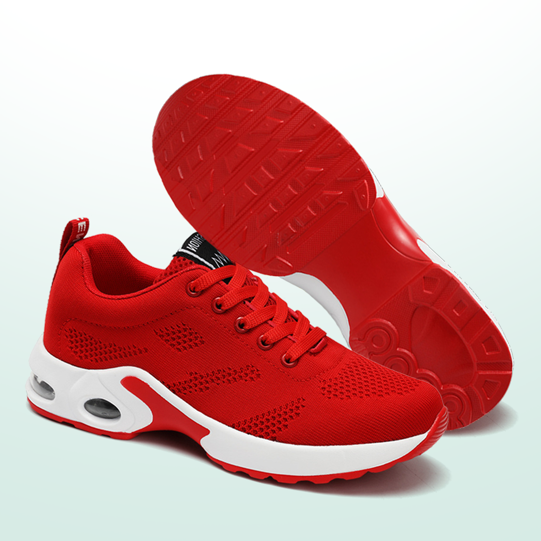 Red women's walking sneakers showing treaded outsole and white midsole detail