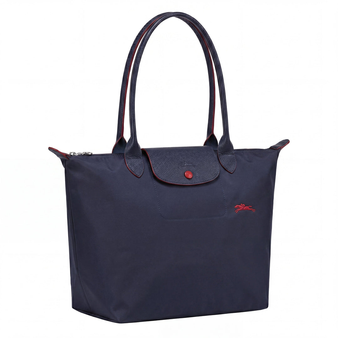 Navy tote bag with top handles, front flap with snap button, small red logo