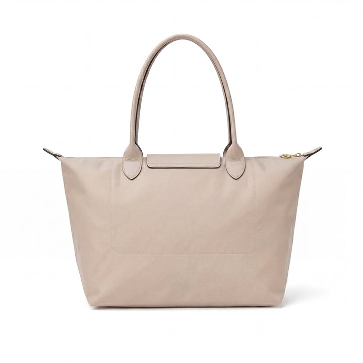 Light beige tote bag with short handles and flap closure, featuring subtle blue logo
