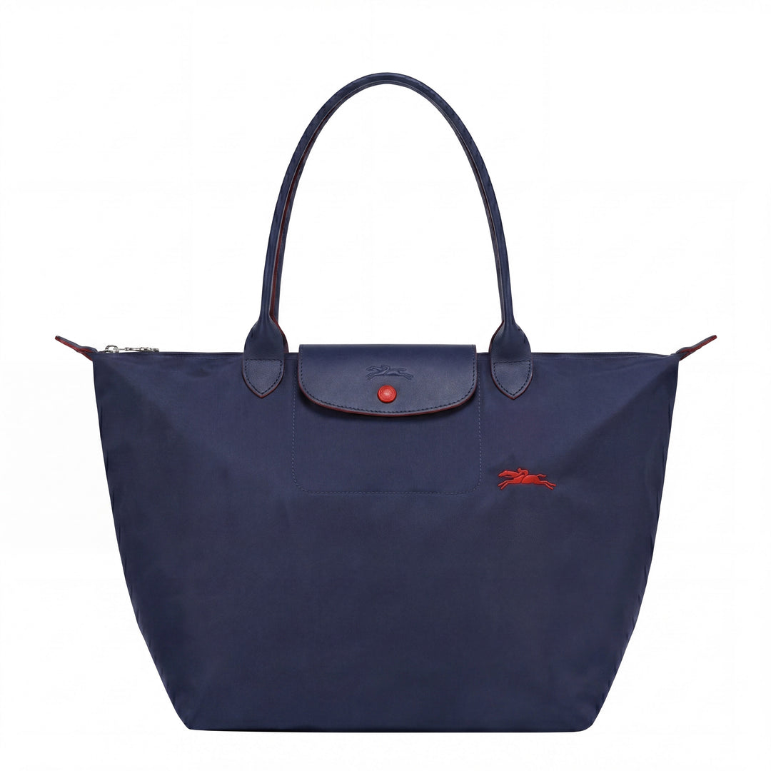Dark blue tote bag with front flap pocket, snap button, and red logo