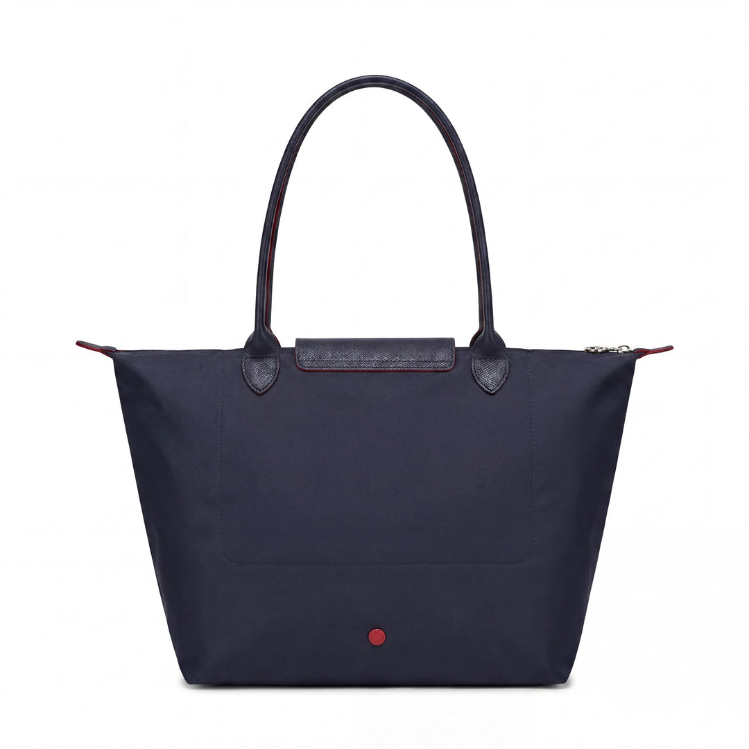 Blue tote bag with front flap pocket and red snap button