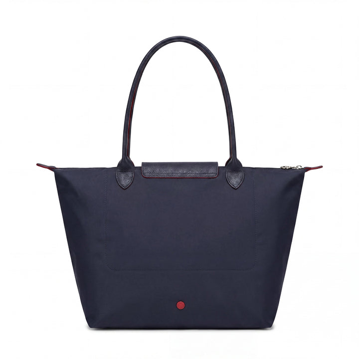 Blue tote bag with front flap pocket and red snap button