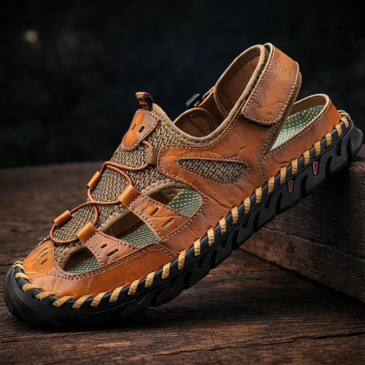 Rugged tan sandals with hook-and-loop straps and patterned lacing accents