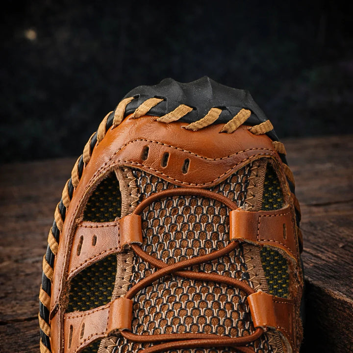 Close-up brown sandals upper with textured mesh inserts and lace-through straps