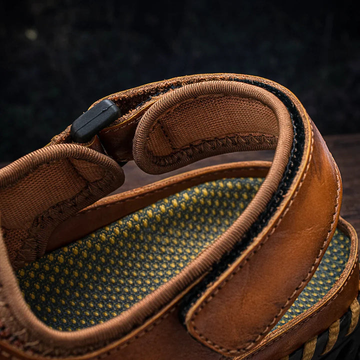 Close-up tan sandal side showing cushioned collar and woven strap panel