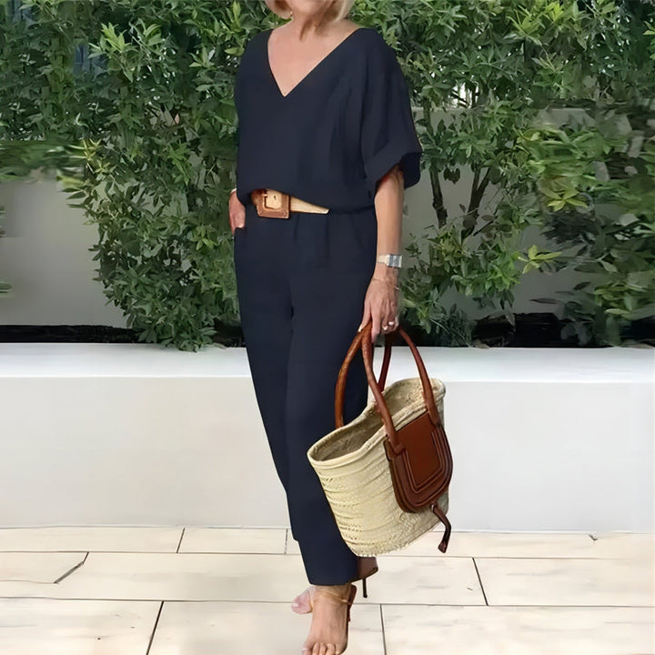 Navy V-neck two-piece set with draped sleeves and matching ankle-length pants